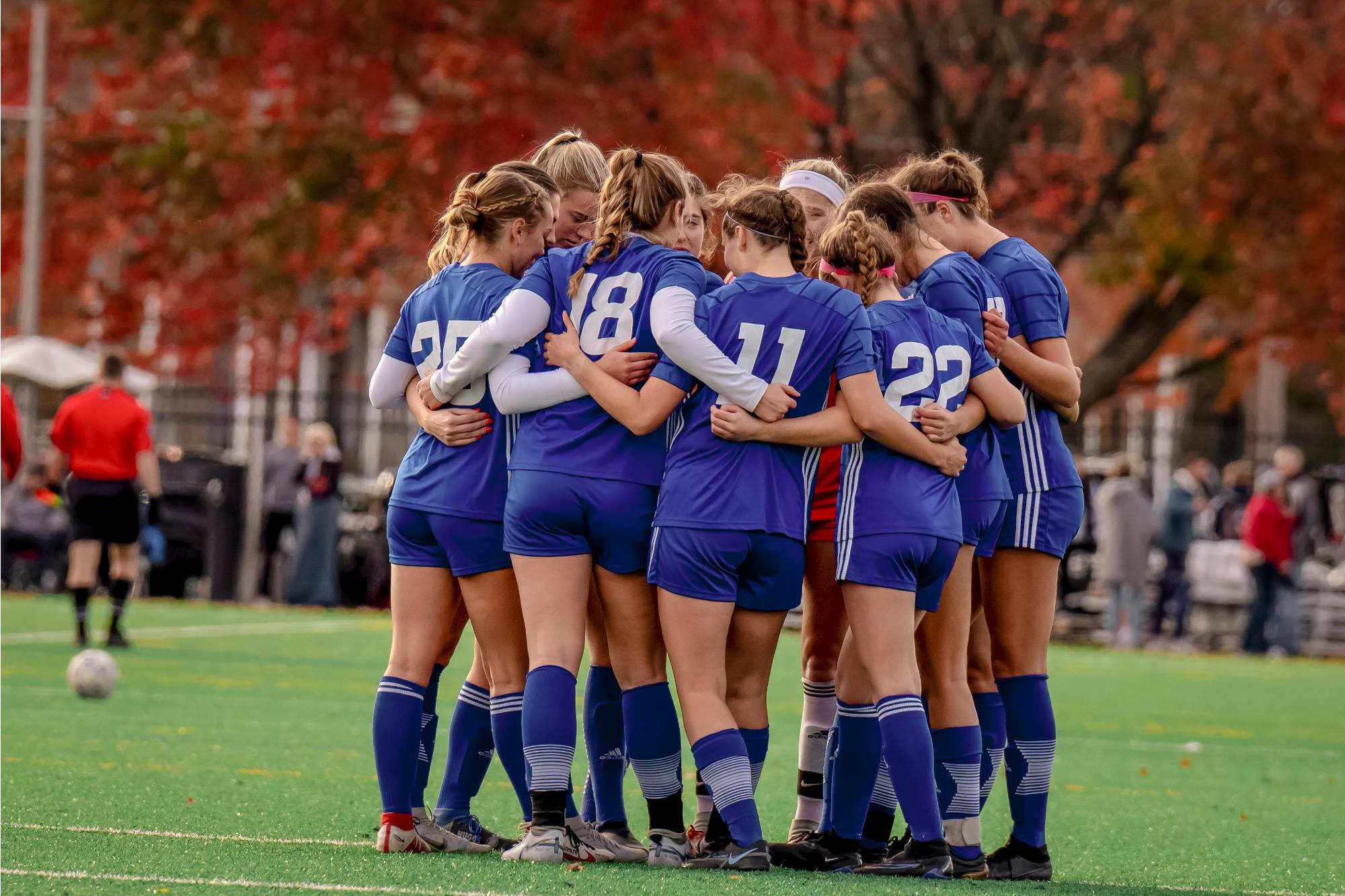 Women's Soccer athletes celebrate a goal during a game.